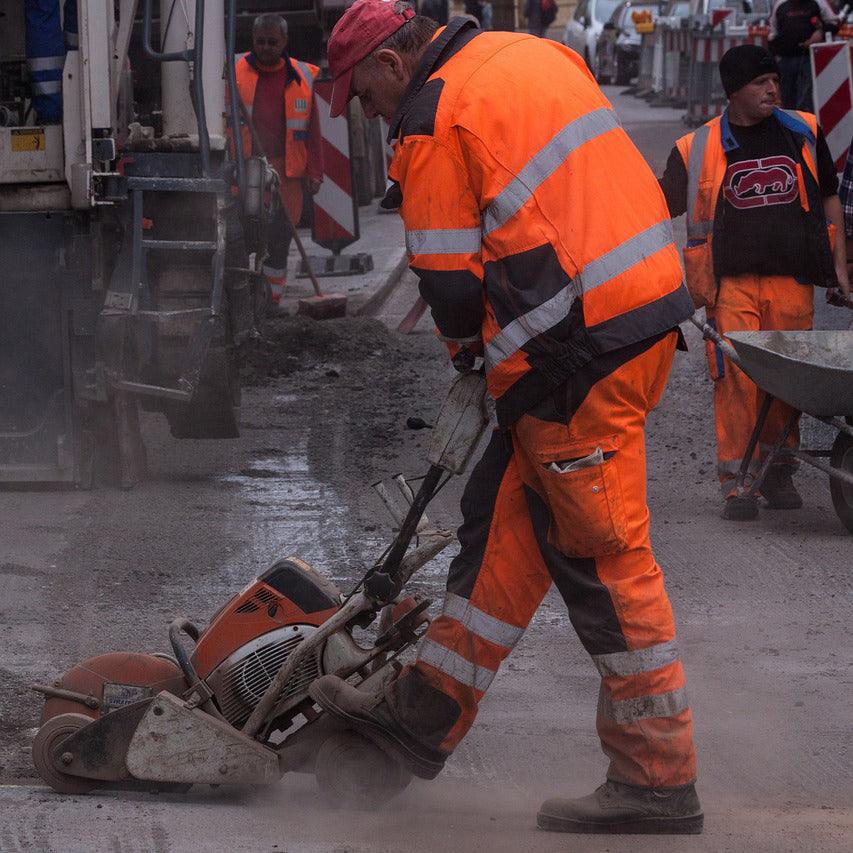 Man jack-hammering sidewalk