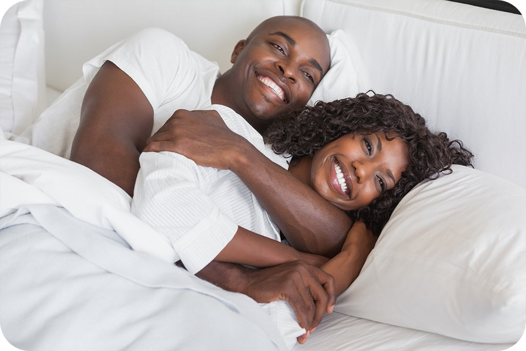 Happy Black Couple in bed smiling