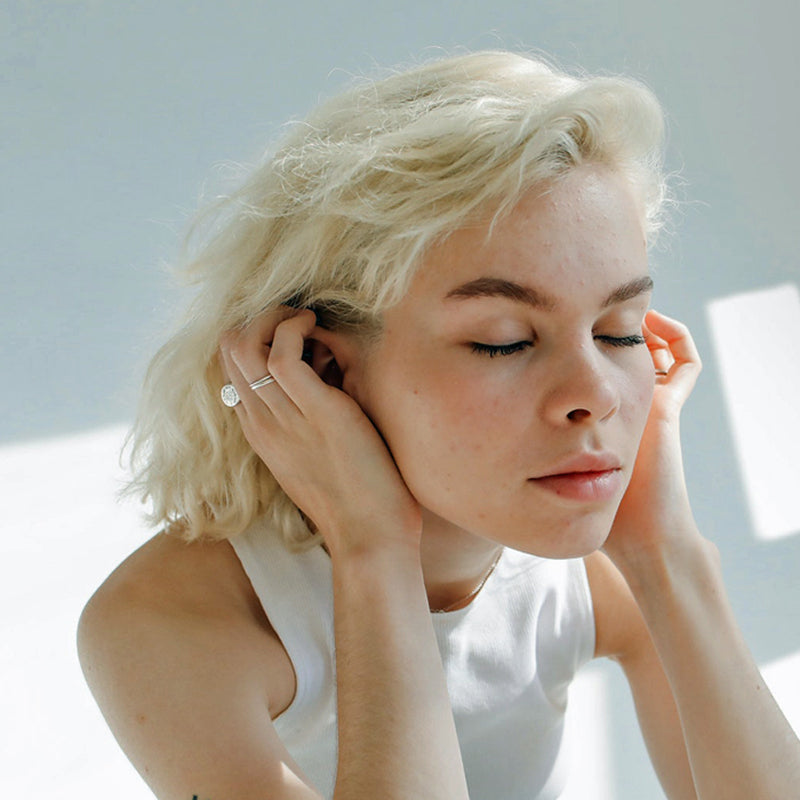 girl with hands over ears is sensitive to noise and uncomfortable